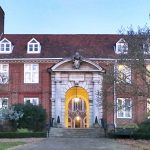 Georgian hall with pedimented arch affording glimpse beyond